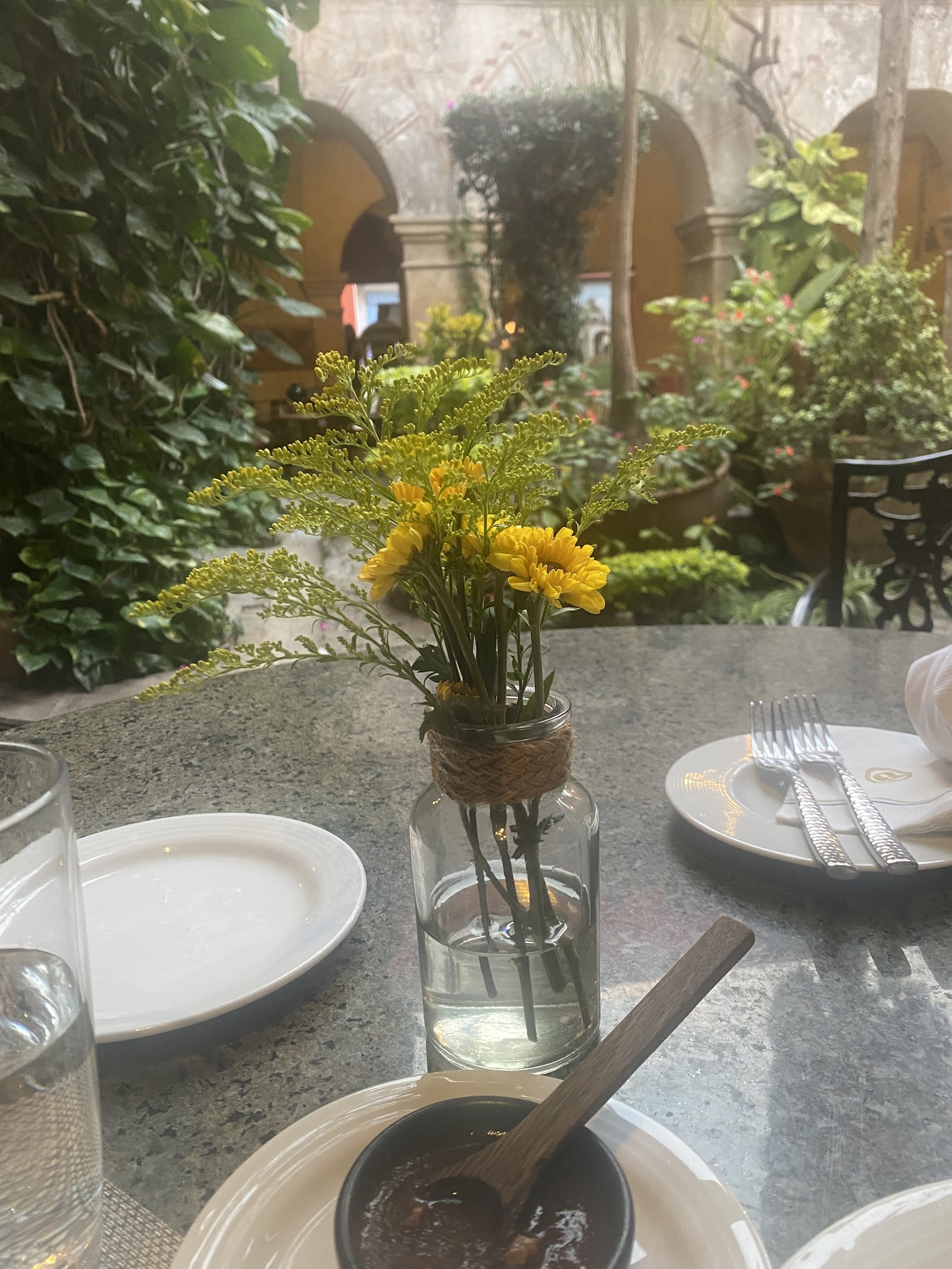 a table set with yellow flowers